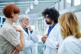 Four healthcare professionals discussing in a hospital