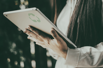 Woman holds check board with recycling symbol