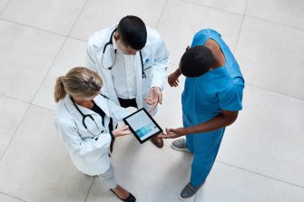 doctors and nurses holding tablet