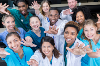A group of health professionals from many fields reach out to the camera