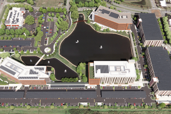 Areal view of AdventHealth campus with solar rooftop arrays featuring over 7,500 solar panels. The system will encompass four building rooftops, two parking garages, and multiple solar canopies throughout the surface parking lot.